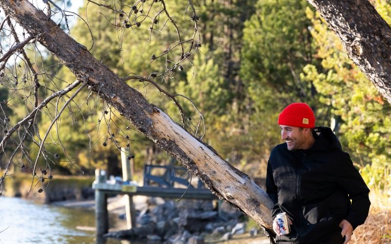 a man standing next to a tree