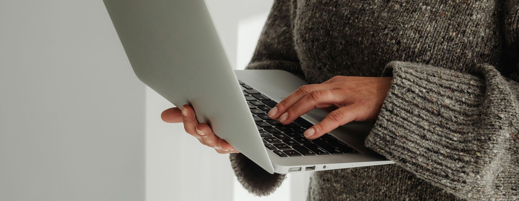 A person holding a laptop.