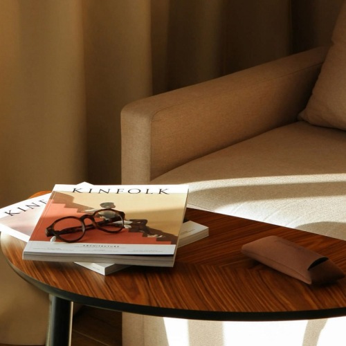 a couch with a books on a table