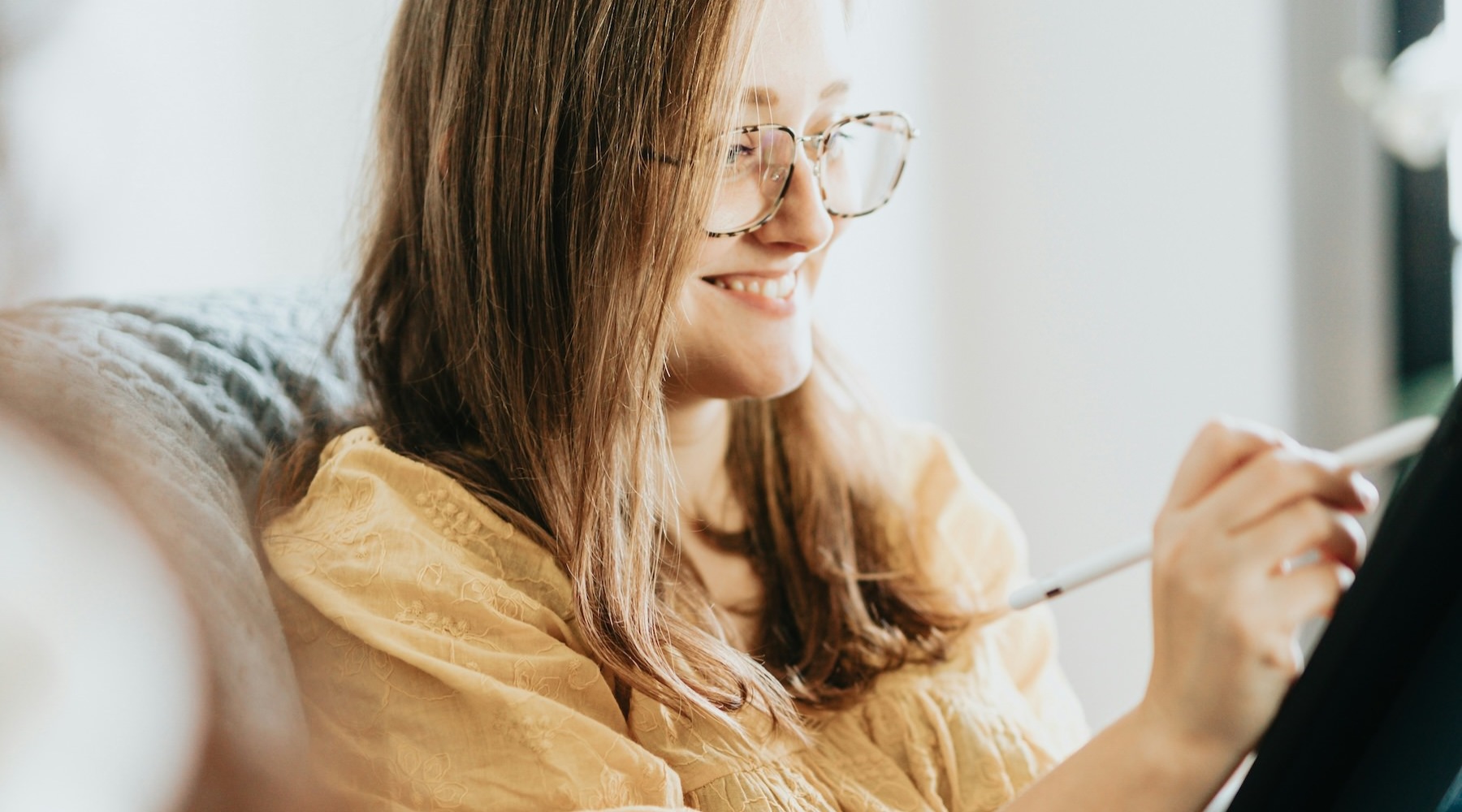 a woman drawing on a tablet
