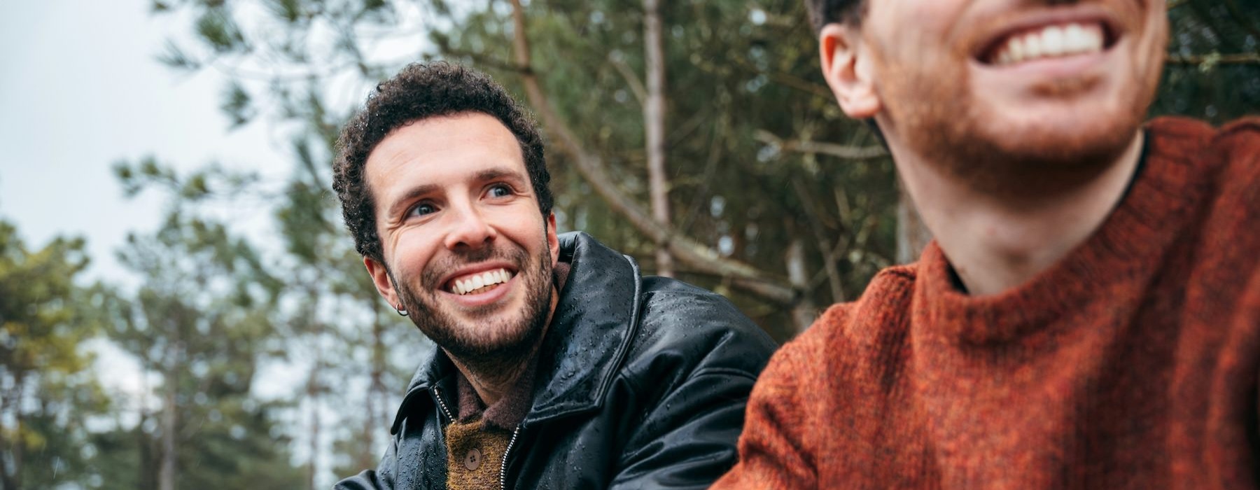 a couple of men smiling