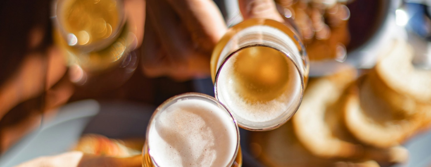 a group of people holding glasses of beer